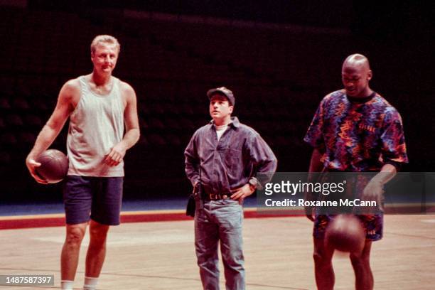 Award-winning basketball players former Boston Celtics Larry Bird and Chicago Bulls Michael Jordan stand on either side of a production team member...