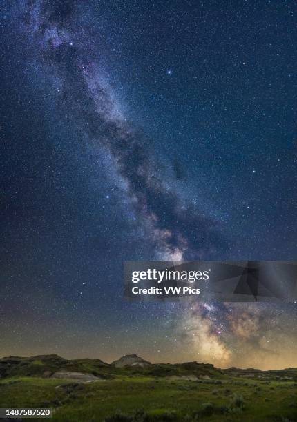 This captures the vertical sweep of the summer Milky Way over the foreground landscape of Dinosaur Provincial Park, Alberta. The image serves as a...