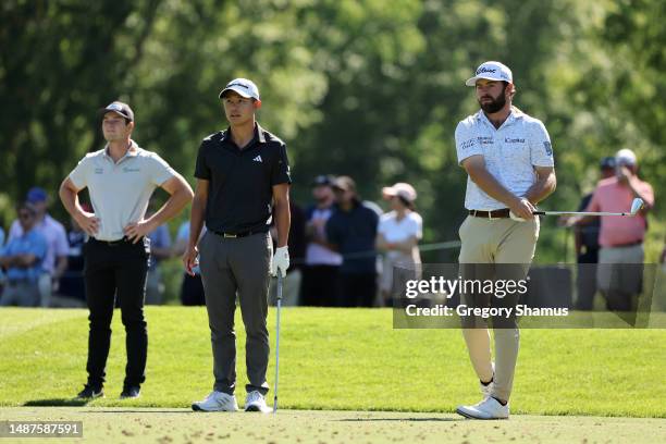 Cameron Young of the United States plays his shot from the 13th tee as Viktor Hovland of Norway and Collin Morikawa of the United States look on...