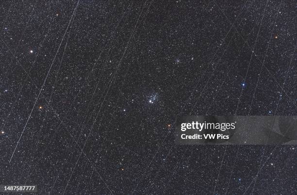 This is NGC 457, the ET or Owl Cluster in Cassiopeia, in a stack of images showing the total number of satellite trails recorded over the 36 minutes...