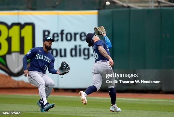 Kolten Wong of the Seattle Mariners make a running catch over his shoulder of a ball hit by Nick Allen of the Oakland Athletics in the bottom of the...