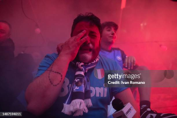 Napoli fans celebrate after winning the Serie A championship near the mural of Diego Armando Maradona on May 04, 2023 in Naples, Italy. SSC Napoli...