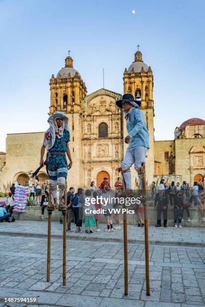 Zancudos de Zaachila stilt dancers in a wedding party on the street in front of the Church of Santo Domingo, Oaxaca, Mexico.
