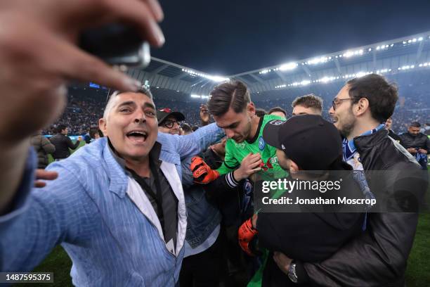 Alex Meret of SSC Napoli is mobbed by fans as they celebrate following the final whistle of the Serie A match between Udinese Calcio and SSC Napoli...