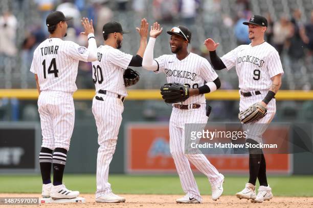 Ezequiel Tover, Harold Castro Jurickson Profar and Brenton Doyle of the Colorado Rockies celebrate their win against the Milwaukee Brewers at Coors...