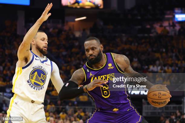 LeBron James of the Los Angeles Lakers is guarded by Stephen Curry of the Golden State Warriors during the first quarter of game two of the Western...