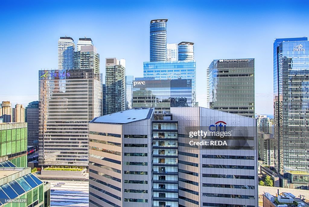 Facades of the skyscrapers of Delta, PWC, CITI Bank, Telus and MarshMcLennan and the nearby high - rise buildings Downtown Toronto, Canada