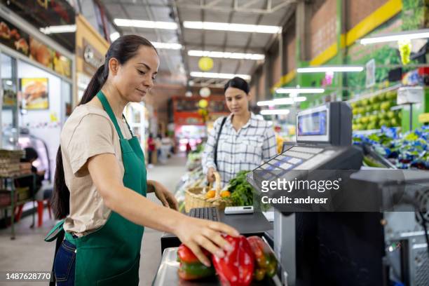 cashier registering products at the supermarket - checkout register stock pictures, royalty-free photos & images