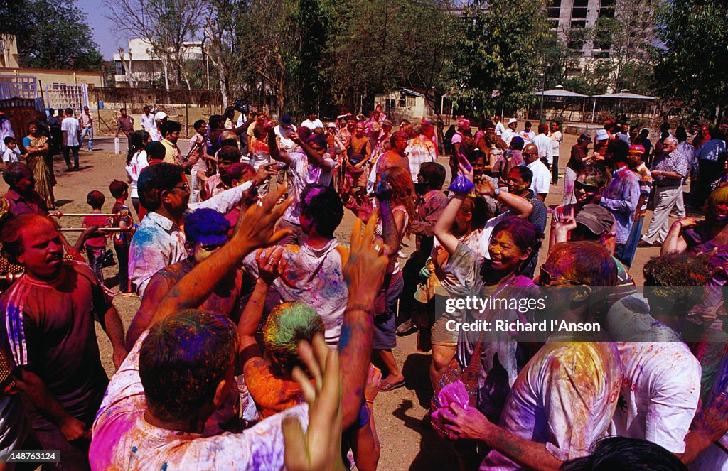 Tourists and locals dancing to celebrate Holi, festival of colours.