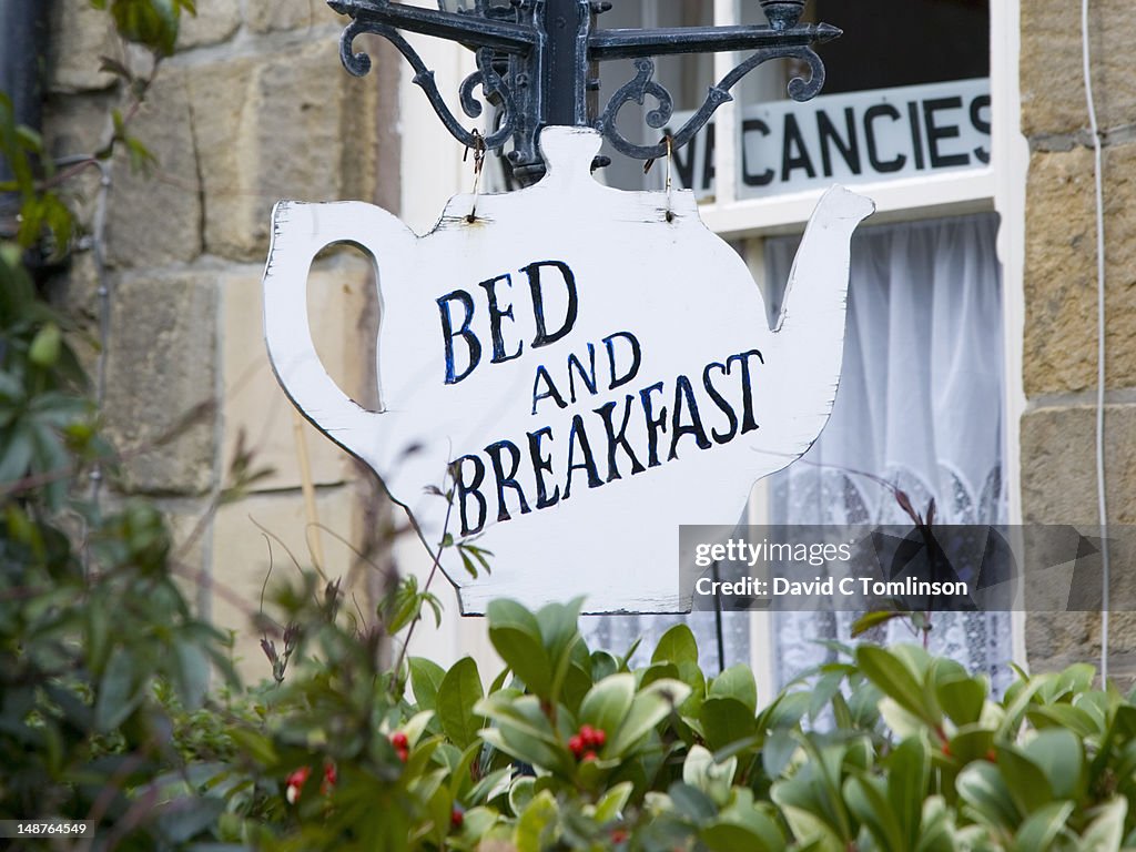 Teapot-shaped sign outside bed and breakfast.