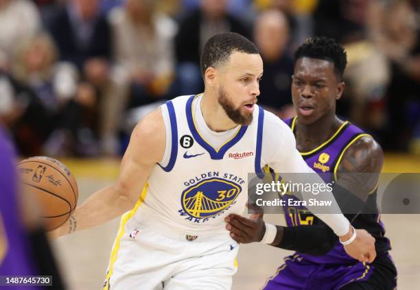 Stephen Curry of the Golden State Warriors controls the ball ahead of Dennis Schroder of the Los Angeles Lakers during the fourth quarter in game two...