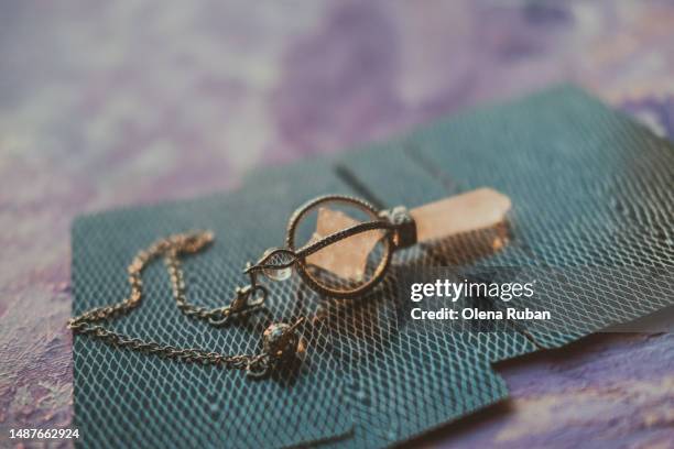 ornate pendulum on tarot cards. - fortune telling stock pictures, royalty-free photos & images