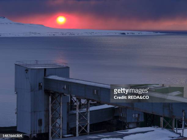 Sunset over the mine. Russian coal mining town Barentsburg at fjord Groenfjorden, Svalbard. The coal mine is still in operation. Arctic Region,...