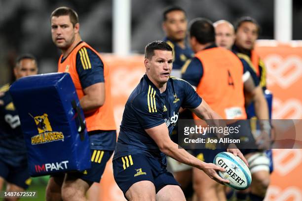 Freddie Burns of the Highlanders warms up ahead of the round 11 Super Rugby Pacific match between Highlanders and Chiefs at Forsyth Barr Stadium, on...