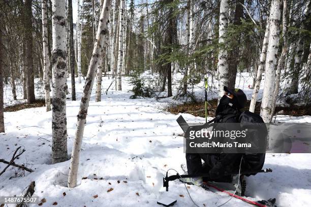 SnowEx researcher Dr. Kelly Gleason works on skis while taking measurements of snow albedo in a section of boreal forest during the melt season on...