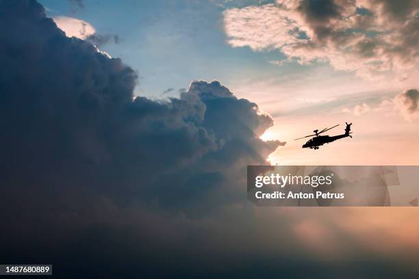 military helicopter in a storm cloud - defence industry stock pictures, royalty-free photos & images