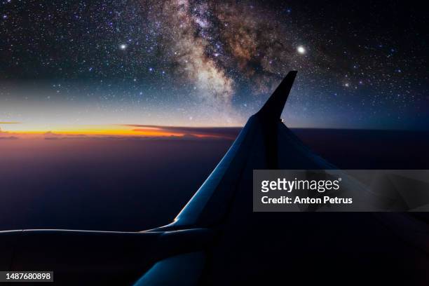 view from the airplane window to the wing at night sky - glides stock pictures, royalty-free photos & images