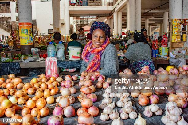 Congolese woman trader in front of her onion and garlic stall at the Total market in Brazzaville, March 24, 2017.