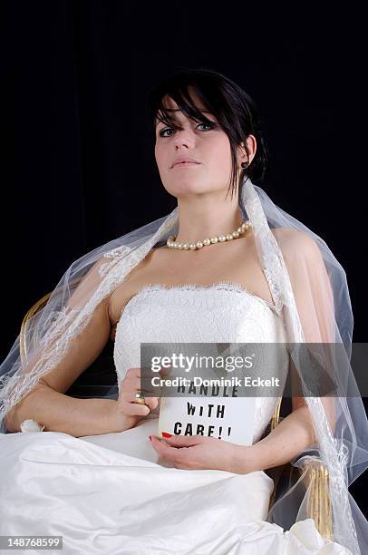 bride with 'handle with care' sign - funny safety signs stock pictures, royalty-free photos & images