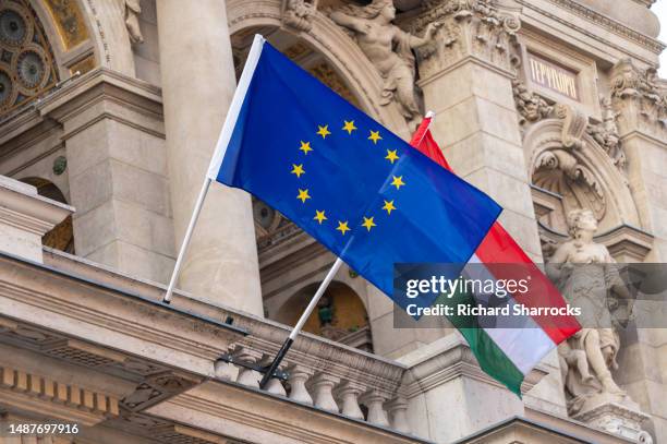eu and hungarian flags - hungría fotografías e imágenes de stock