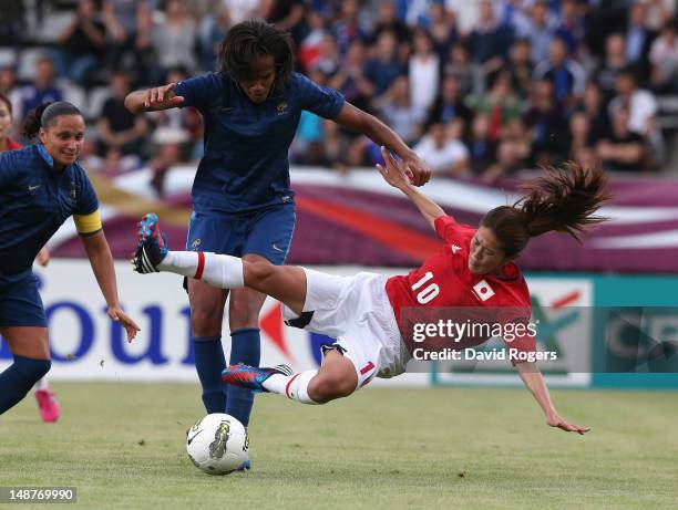 Homare Sawa of Japan is challenged by Wendie Renard during the friendly international match between Japan Women and France Women at Stade Charlety on...