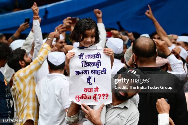 New Delhi, India – May 01: A Girl with poster during the ongoing wrestlers protest against WFI chief Brij Bhushan Singh at Jantar Mantar in New Delhi...