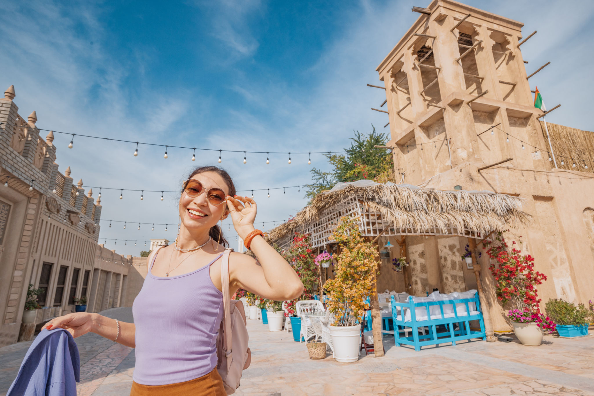 Tourist girl at Al Fahidi historical district and Bur Dubai neighbourhood. Travel and historical attractions of United Arab Emirates Tourist girl at Al Fahidi historical district and Bur Dubai neighbourhood. Travel and historical attractions of United Arab Emirates