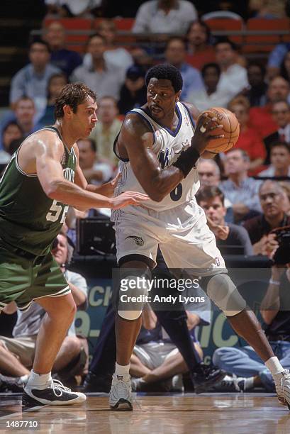 Orlando Magic center Patrick Ewing holds the ball as Boston Celtics forward Vitaly Potapenko plays defense during the NBA game at the TD Waterhouse...