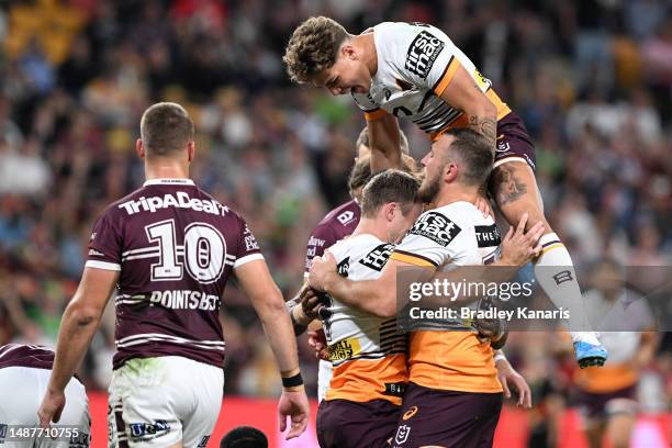 Billy Walters of the Broncos celebrates with team mates after scoring a try during the round 10 NRL match between Manly Sea Eagles and Brisbane...