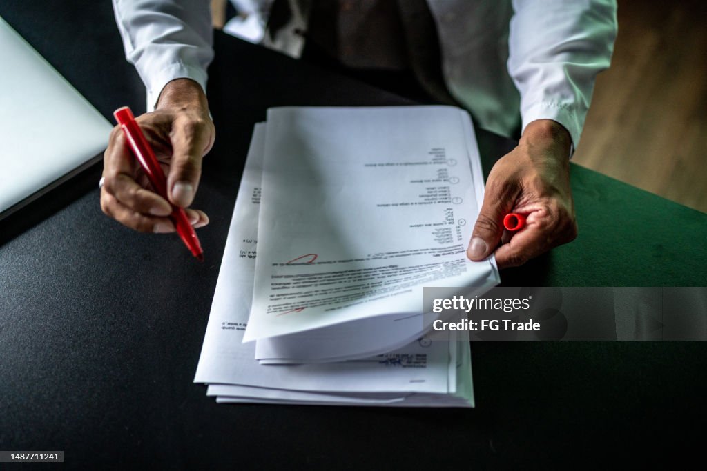 Teacher grading educational tests in the classroom