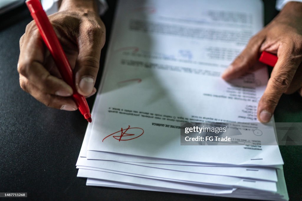 Teacher grading educational tests in the classroom