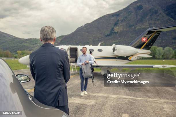 businessman disembarking from private jet - status symbol stock pictures, royalty-free photos & images