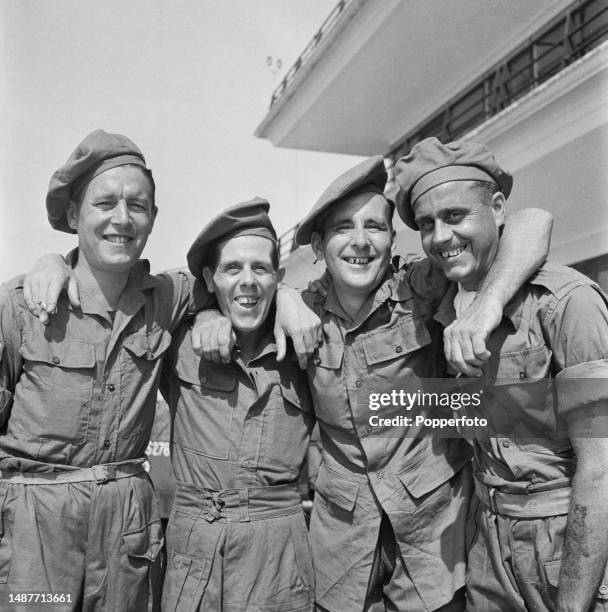 Recently released British Army prisoners of war from the Manchester Regiment prepare to board a plane home at Singapore Airport following the...