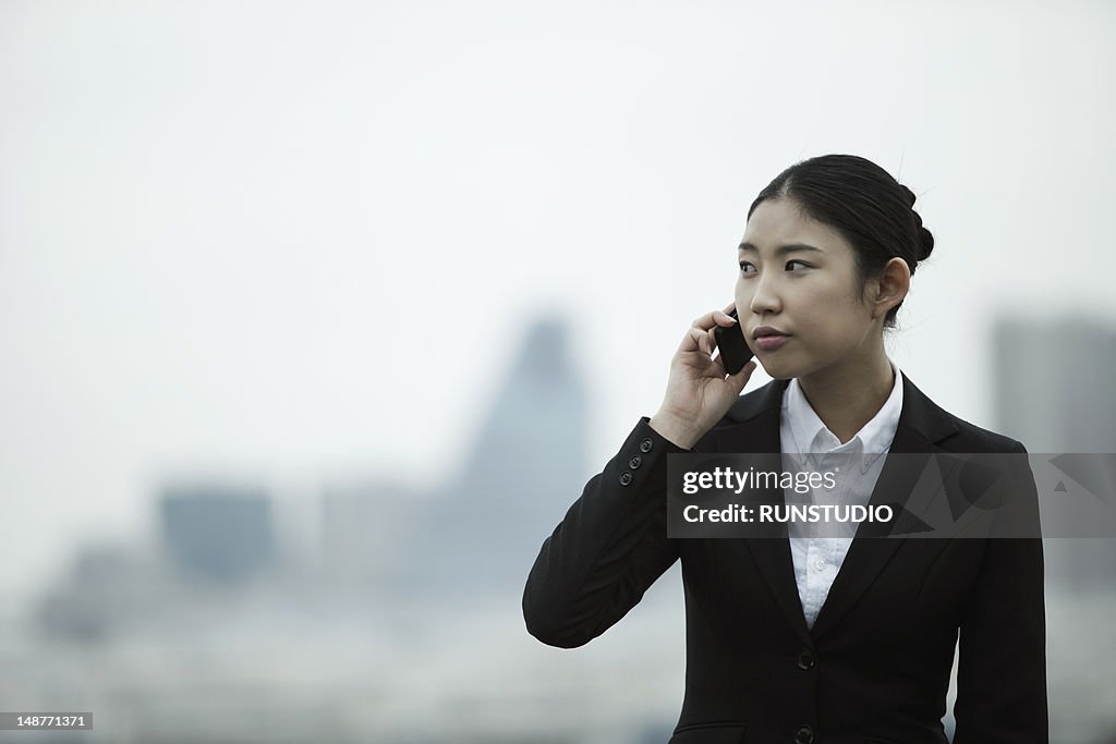 Business woman talking mobile phone