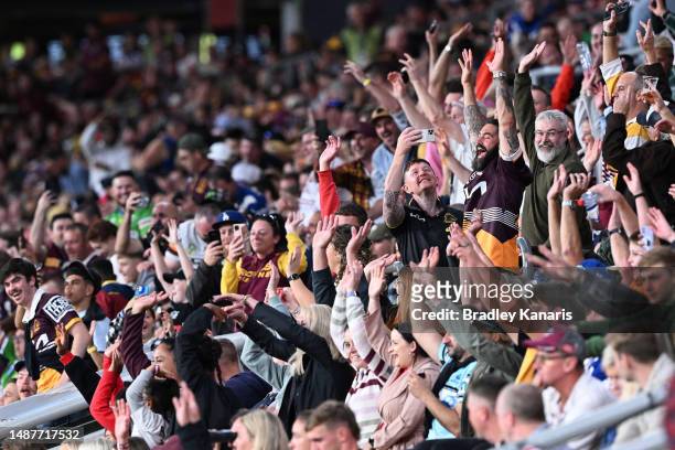 Spectators in the crowd cheer during the round 10 NRL match between Manly Sea Eagles and Brisbane Broncos at Suncorp Stadium on May 05, 2023 in...