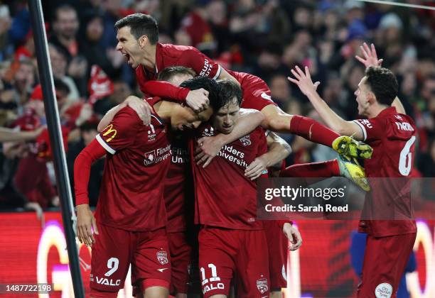 Craig Goodwin of United celebrating his second goal with team mates Hiroshi Ibusuki of Adelaide United and Isaias of Adelaide United and Louis...