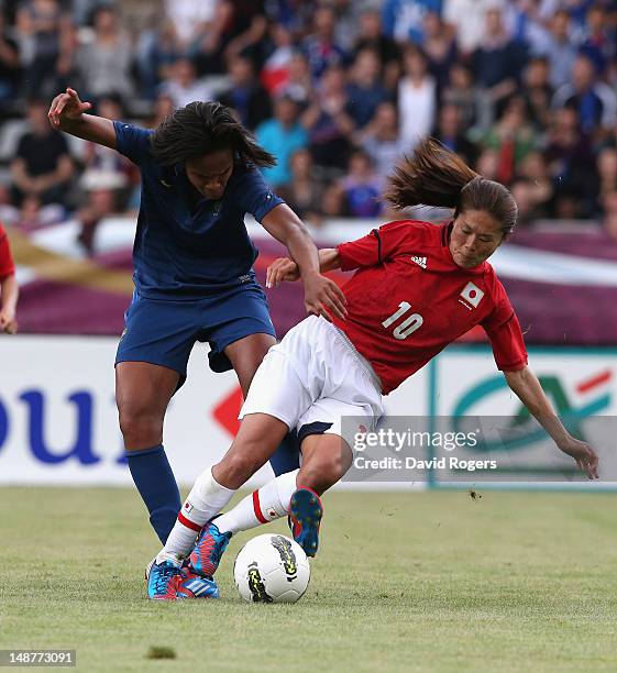 Homare Sawa of Japan is challenged by Wendie Renard during the friendly international match between Japan Women and France Women at Stade Charlety on...
