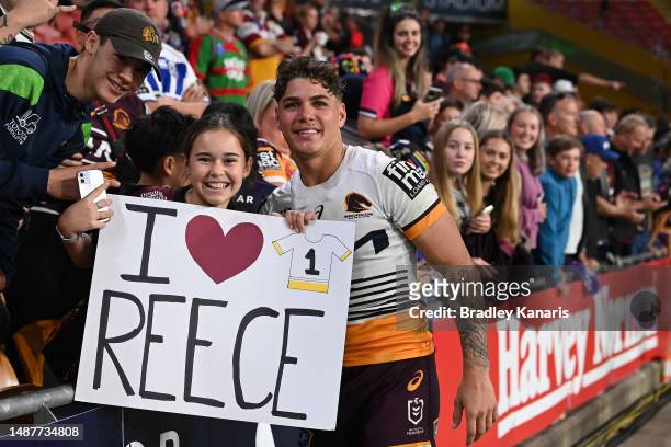 Reece Walsh of the Broncos poses for a photo with a fan after the round 10 NRL match between Manly Sea Eagles and Brisbane Broncos at Suncorp Stadium...