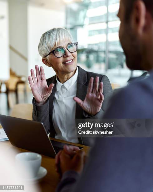 female insurance agent talking to her customer on a meeting in the office. - finance and economy stock pictures, royalty-free photos & images