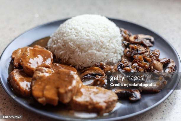pork tenderloin in sauce with rice and mushrooms - white rice stock pictures, royalty-free photos & images