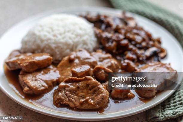 pork tenderloin in sauce with rice and mushrooms - tenderloin stock pictures, royalty-free photos & images