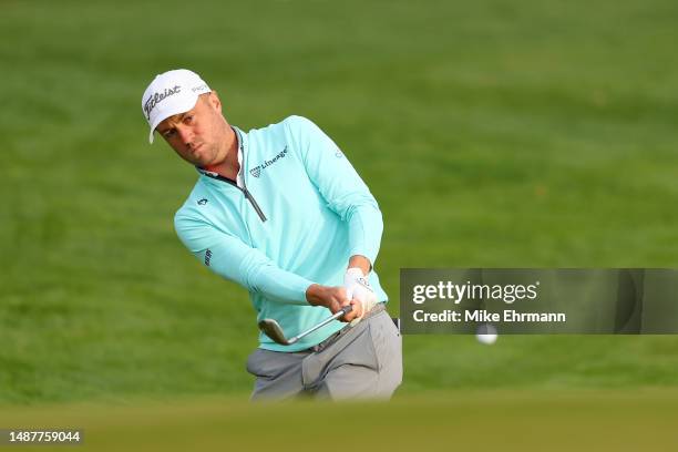 Justin Thomas of the United States chips on the tenth green during the second round of the Wells Fargo Championship at Quail Hollow Country Club on...