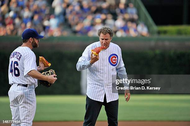 Ryan Dempster of the Chicago Cubs , and Will Ferrell eat pizza on the field before the game against the Miami Marlins at Wrigley Field on July 18,...