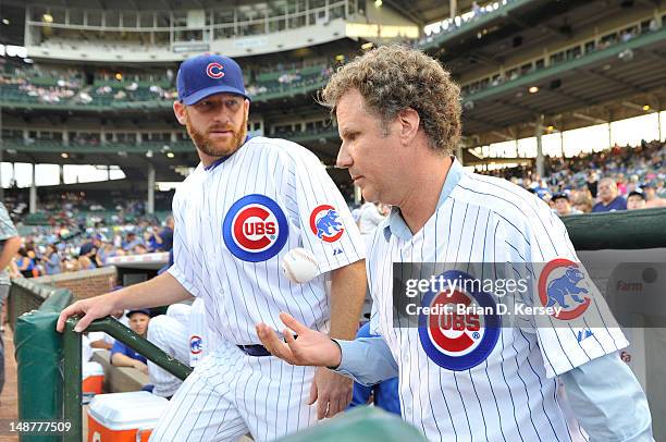 Will Ferrell walks out onto the field with Ryan Dempster of the Chicago Cubs before throwing out a ceremonial first pitch before the game against the...