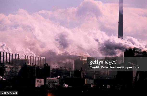 Factory chimneys emit pollutants into the atmosphere over the town of Espenhain in the state of Saxony in East Germany in February 1990. A lot of air...
