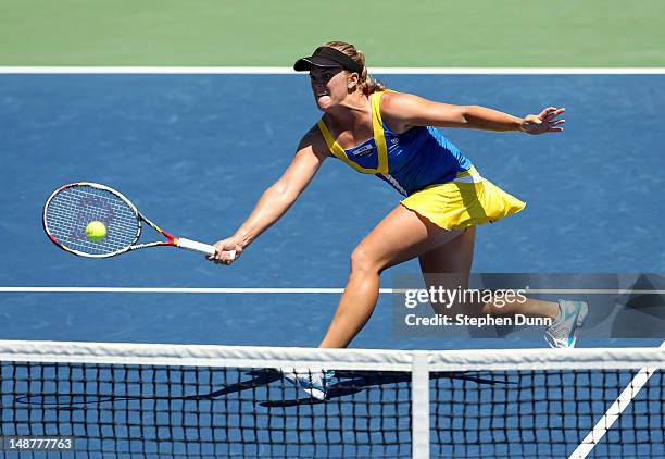 Melanie Oudin hits a shot at the net to Urszula Radwanska of Poland during day six of the Mercury Insurance Open Presented By Tri-City Medical at La...