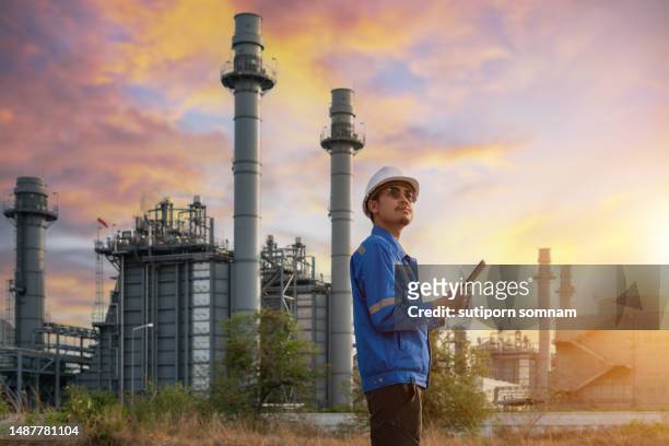 engineer and gas turbine electrical power plant at sunset - gas plant sunset stock-fotos und bilder