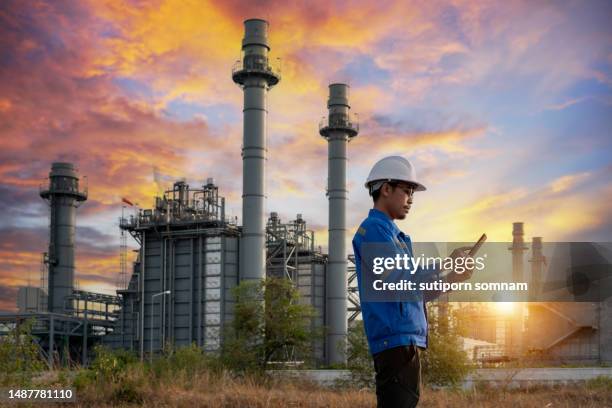 engineer use tablet at gas turbine electrical power plant - gas turbine electrical power plant stock pictures, royalty-free photos & images