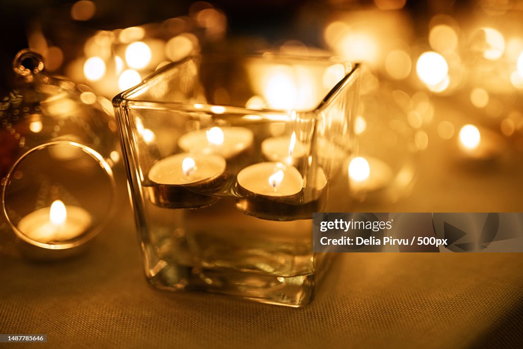 Burning candles on a dark night in a wooden lantern,Romania