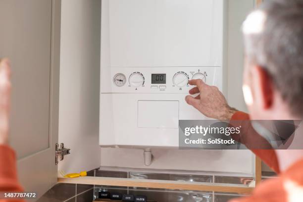adjusting the boiler at home - adjusting stock pictures, royalty-free photos & images